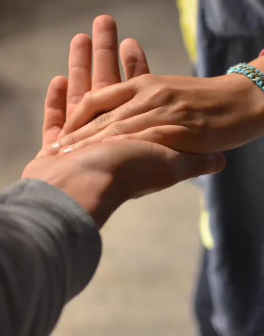 Image of two people holding hands